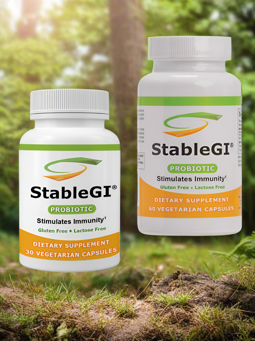 StableGI Dual Pack probiotic supplements, travel-sized and full-sized bottles, outdoor setting.